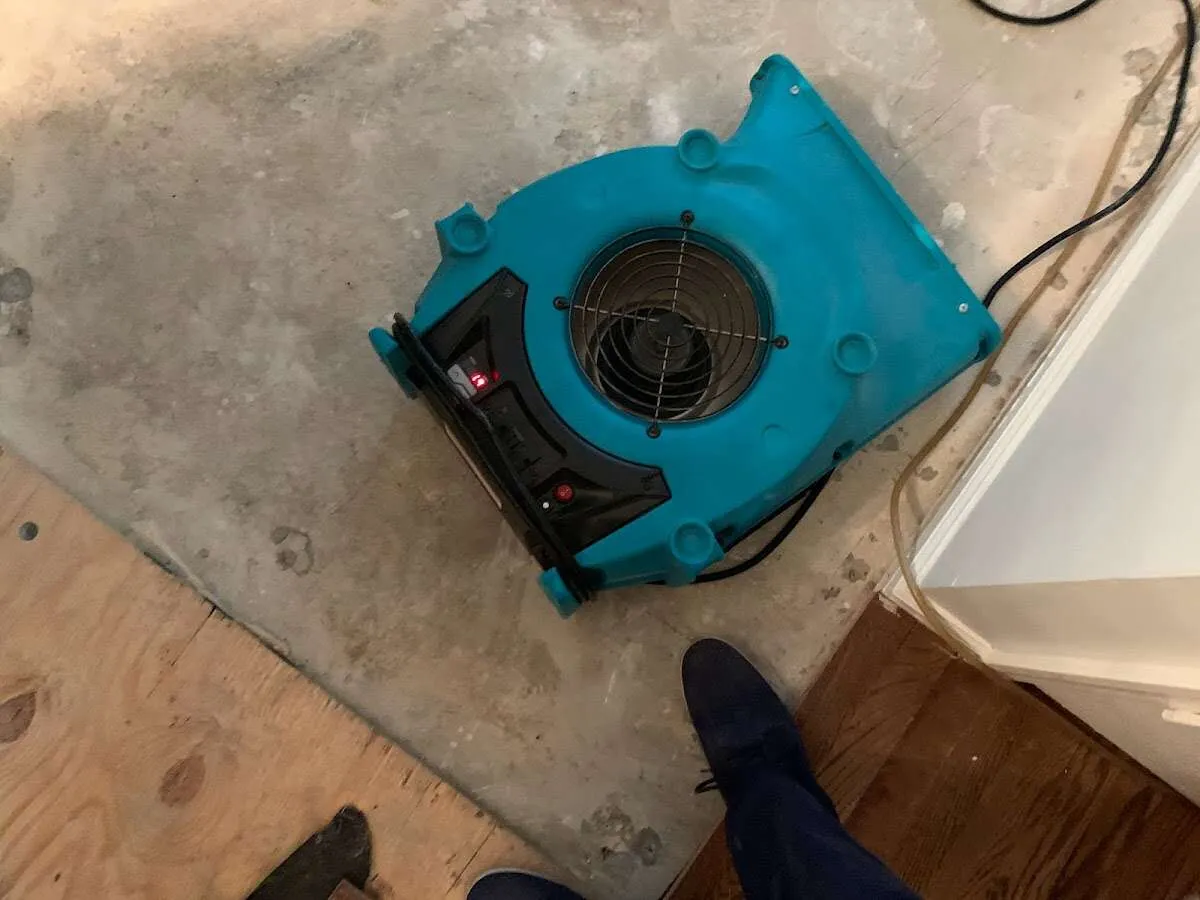 Air mover drying subfloor during Commercial Water Damage Restoration in Hockessin